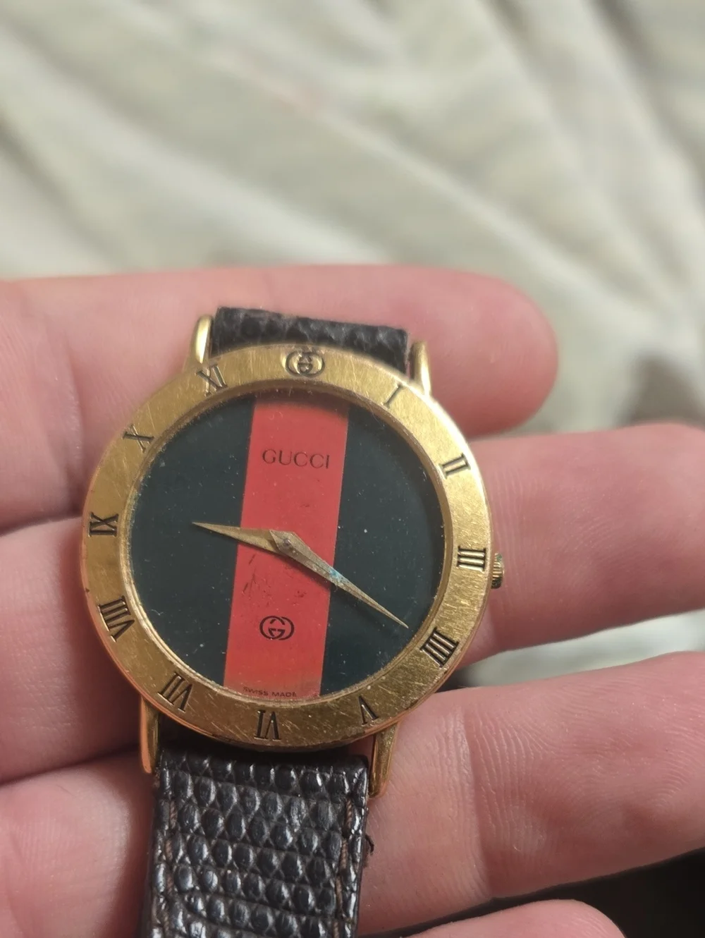 Gucci Gold-Tone Watch with Black Dial and Red Stripe